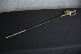A 19th century officer's dress sword with dress knot and etched blade in brass mounted leather