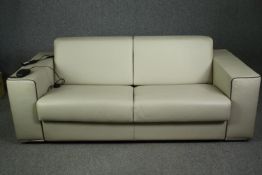A contemporary Italian sofa bed by Giannini design in piped leather with motorized action. 4' 6