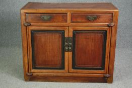 Sideboard, Chinese hardwood with ebonised panel doors on block supports. H.88 W.104 D.48cm.