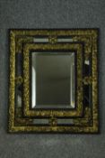 Wall mirror, late 19th century Flemish cushion frame with repousse metalwork and bevelled plate. H.