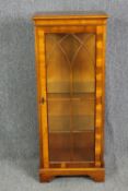 A 19th century style yewwood display cabinet. H.122 W.49 D.33cm.