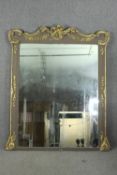 Overmantel mirror, 19th century carved and painted with Rococo gilt gesso decoration. H.178 W.211cm.