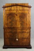 A 19th century Continental Biedermeier two section walnut escritoire cabinet with secretaire