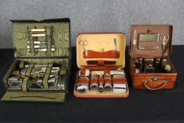Three vintage mid 20th century travelling dressing table sets, H.8 W.30 D.19cm. (largest).