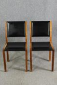 A pair contemporary Heal's teak and black leather dining chairs