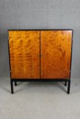 Hall cupboard or linen cabinet on stand, mid century ebonised and section veneered birch. H.139 W.