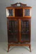 An Edwardian mahogany carved and glazed display cabinet, H.190 W.94 D.40cm.