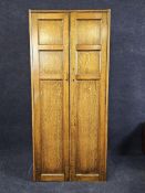 A narrow oak wardrobe, first half 20th century with maker's label. H.73 W.76 D.40cm.