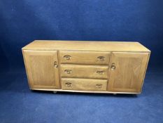 An Ercol elm sideboard. H.70 W.157 D.44.cm