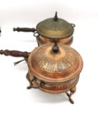 A pair of early 20th century Iranian Nader copper cooking pots with burners with figural design.