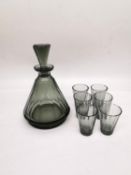 A Czechoslovakian Art Deco smoky faceted conical glass decanter with six matching shot glasses.