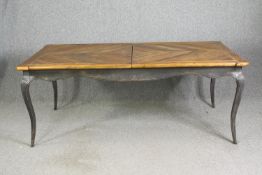 A French provincial farmhouse style extending dining table with a parquetry fruitwood top, and