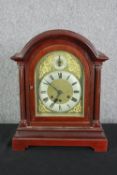 A walnut mantel clock in the Georgian style. H.42 W.34 D.20cm.