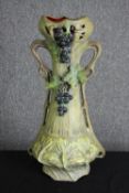 An Art Nouveau pottery vase, in the manner of Royal Dux, early 20th century. H.56cm.