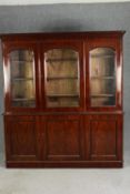 A Victorian triple fronted mahogany library bookcase. H.208 W.188 D.40cm.