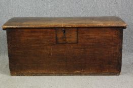 An antique hardwood lidded chest. H.57 W.120 D.55cm.
