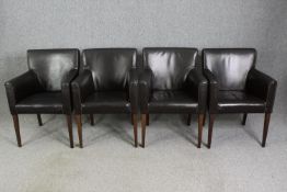 A set of four leatherette upholstered dining chairs.