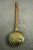 A late 19th century brass bed warming pan. L.99cm.