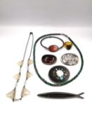 A mixed collection of jewellery, including a Mexican silver fish brooch, an amber and silver brooch,