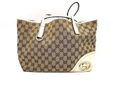 A Gucci GG canvas brtitt large tote bag beige and ebony, red, green and white striped interior. Base