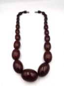 An early 20th century Cherry amber graduated oval bead necklace. (clasp has been replaced) Largest