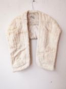 A vintage white mink fur sole with front pockets, with designer label 'National Fur Co Ltd. and