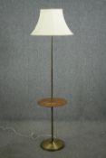 A mid 20th century brass and teak standard lamp. H.172cm.