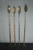 † A collection of four African reliquary carved wood and brass guardians from the Bakota people. H.