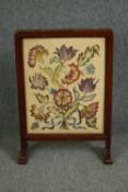 Two early 20th century mahogany and embroidered fire screens. H.79 W.57cm. (largest). (one in need