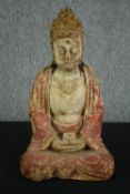 † A 19th century carved and painted Chinese buddha in lotus position. H.50cm.