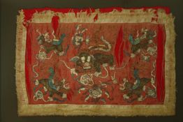 † Tibetan silk embroidery with Buddhistic lions, framed and glazed. H.105 W.126cm.
