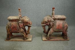 † A pair of 19th century carved and painted Indian elephant and Mahout stands. H.94 W.76 D.35cm. (