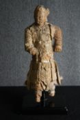 † A 19th century Chinese carved figure of a Chinese warrior in traditional robes. H.66cm.