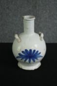 A Delft water bottle, probably 18th century. H.20cm.