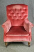 A Victorian armchair, with pink button back upholstery. H.95cm.