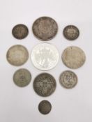 A collection of ten white metal coins, including a silver proof Alderney two pound commemorative