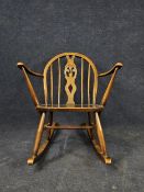An Ercol Golden Dawn elm and beech child's rocking chair