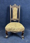 A late Victorian carved walnut prie dieu chair.
