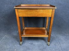 A mid 20th century teak trolley. H.72 W.106 D.37cm