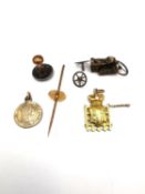 A yellow metal (tests as 18ct gold) portcullis charm, a yellow metal (tests as 9ct gold) pin and