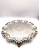 A Victorian silver three footed mint/card tray with engraved scrolling design and scrolling