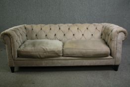 A contemporary Chesterfield sofa by Andrew Martin with beige buttoned textured upholstery. H.77 W.