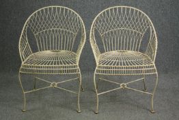 A pair of French 19th century white painted metal wirework garden chairs.