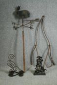 A 19th century cast iron weather vane, a cast iron dolphin doorstop, a wall bracket and and an