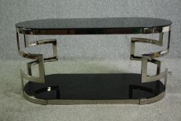 A contemporary Andrew Martin black glass and chrome two tier coffee table. H.56 W.117 D.56cm.