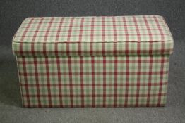 A contemporary ottoman with chequered upholstery. H.52 W.106 D.51cm.