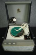 A vintage portable record player by Garrard, in a Dynatron case. H.22 W.38 D.42cm.