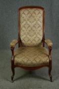 A late Victorian walnut open armchair. H.112cm.