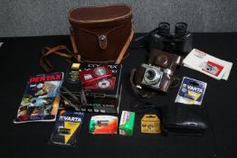A group of three cameras including Pentax, Voigtländer and a Nikon digital camera with