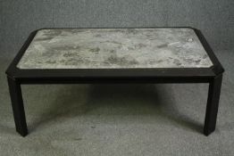 A contemporary granite topped coffee table on an ebonized base. H.50 W.137 D.88cm.